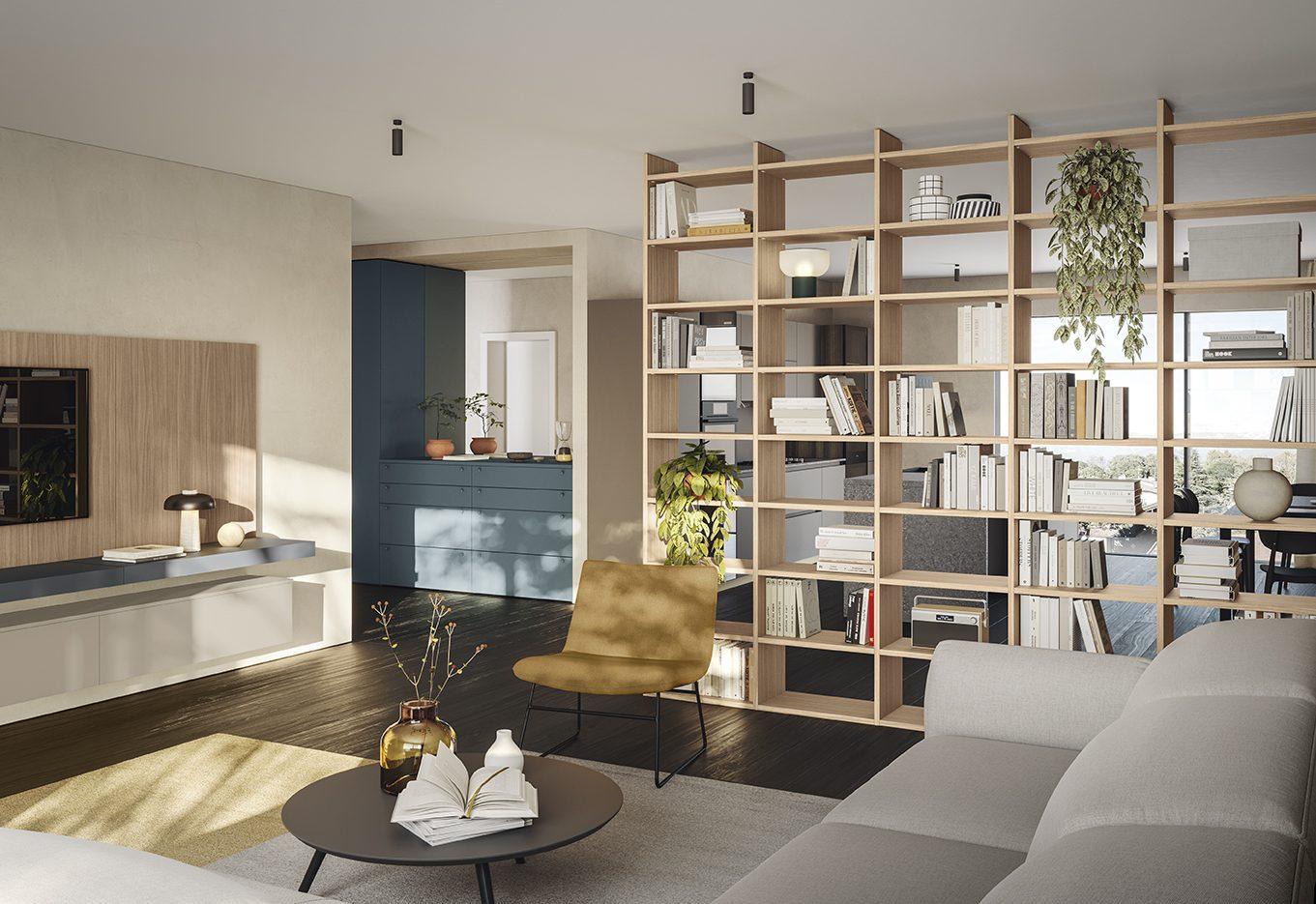 Salotto con grande libreria in legno chiaro a tutta parete, poltroncina senape e divano grigio in primo piano