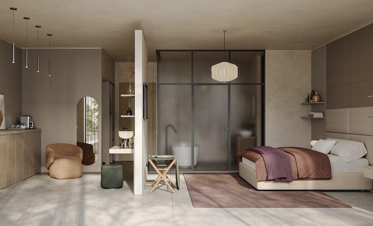 Camera d'hotel open space con letto matrimoniale in tessuto tortora, angolo bagno con parete vetrata e zona toilette con specchio ad arco