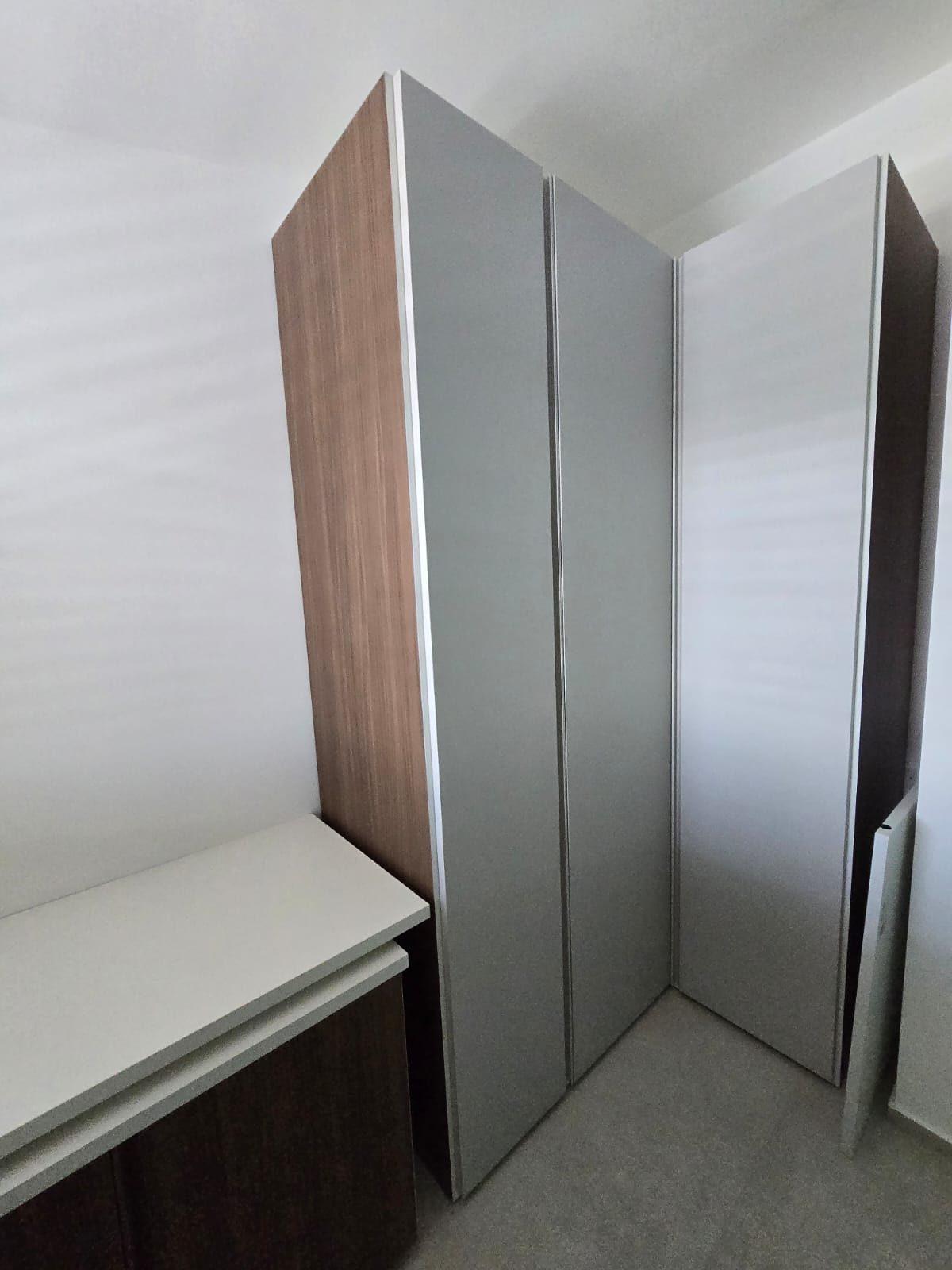 Armadio ad angolo con ante grigio perla e fianco in legno naturale
