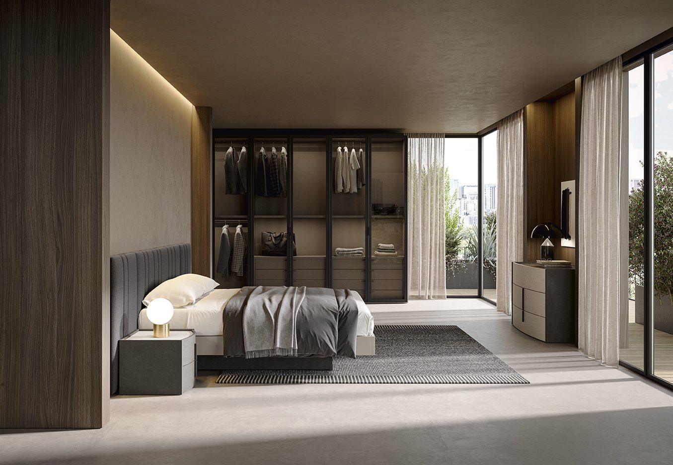 Camera da letto con testata imbottita a righe verticali grigio antracite, cabina armadio a vista con ante in vetro fumè su profilo nero e comò laccato tortora con dettagli neri